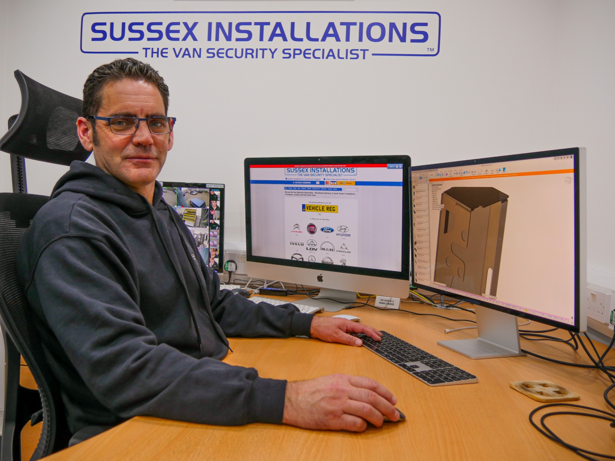 Jeff Scott managing director sat at his desk with CAD software open on the computer as he is also the main product designer at Sussex Installations